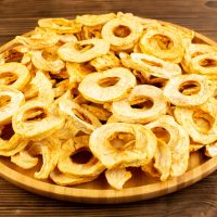top-view-pineapple-dried-rings-inside-plate-dried-fruits-sour-tasty-unique-taste-brown-wooden-desk-fruits-exotic-dry